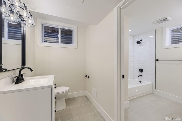 full bathroom with vanity, toilet, tiled shower / bath combo, and tile patterned flooring