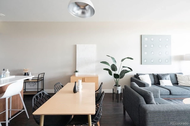 living room with baseboards and dark wood-type flooring