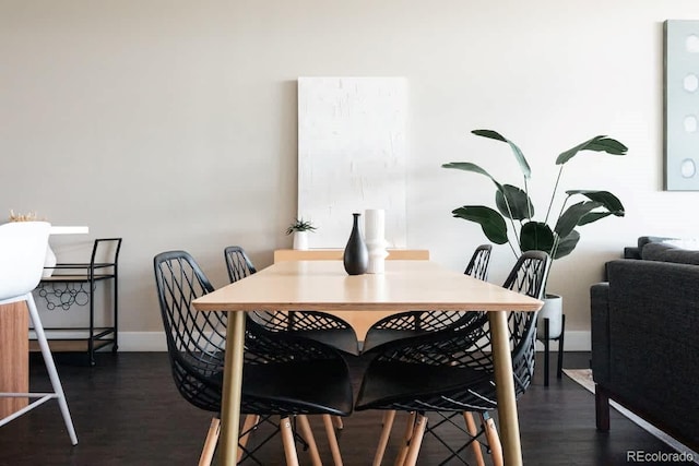 dining room with dark wood-style floors and baseboards