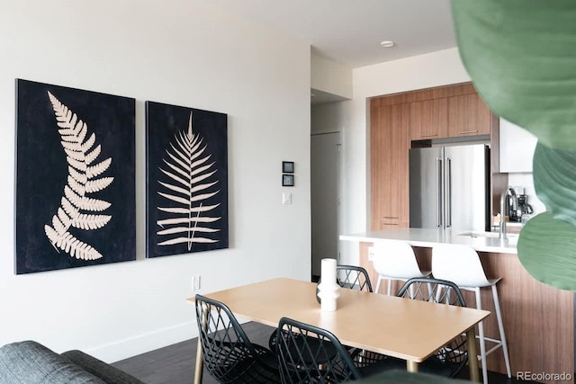 dining room featuring baseboards and dark wood-style flooring