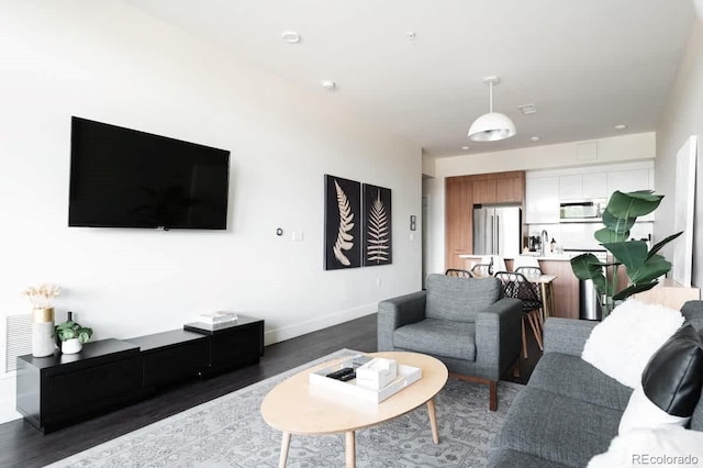 living room with baseboards and wood finished floors