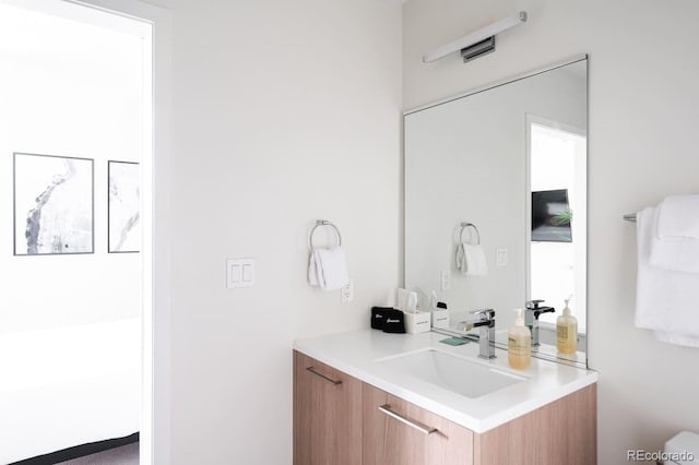 bathroom with toilet and vanity