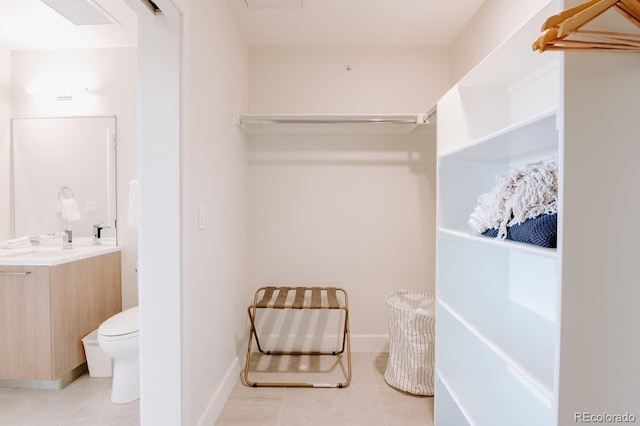 walk in closet featuring light tile patterned floors