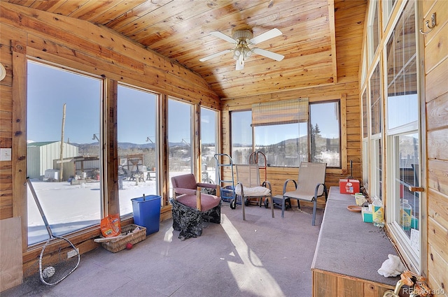 sunroom featuring a mountain view, a healthy amount of sunlight, wooden ceiling, and vaulted ceiling