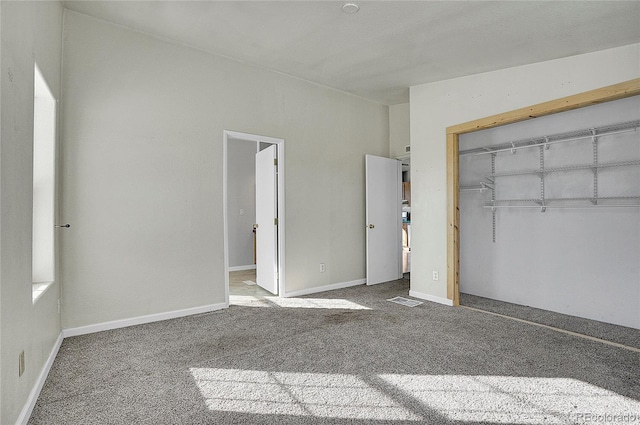 unfurnished bedroom with carpet flooring and a closet