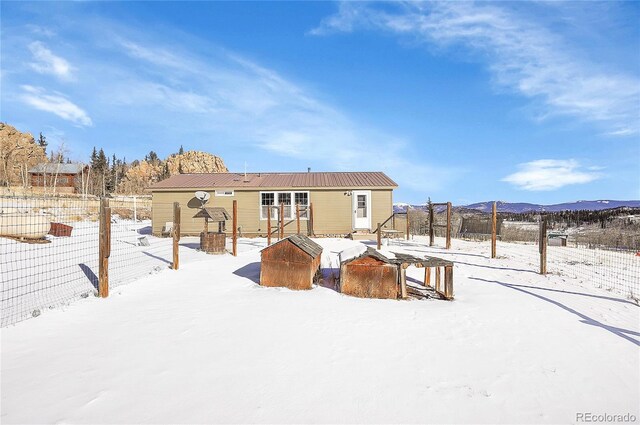 snow covered house with a mountain view