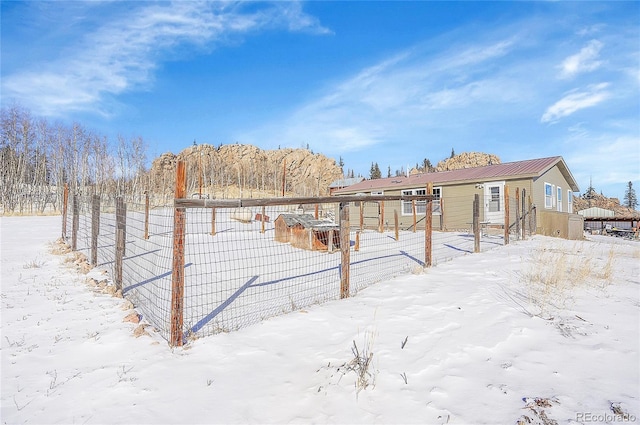 view of snow covered rear of property