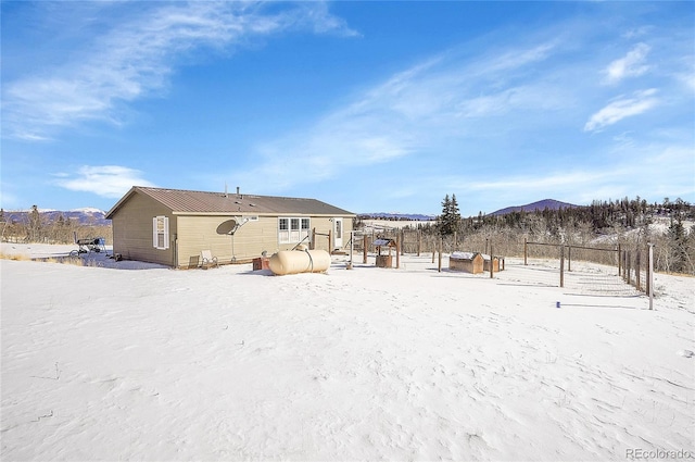 snow covered property featuring a mountain view