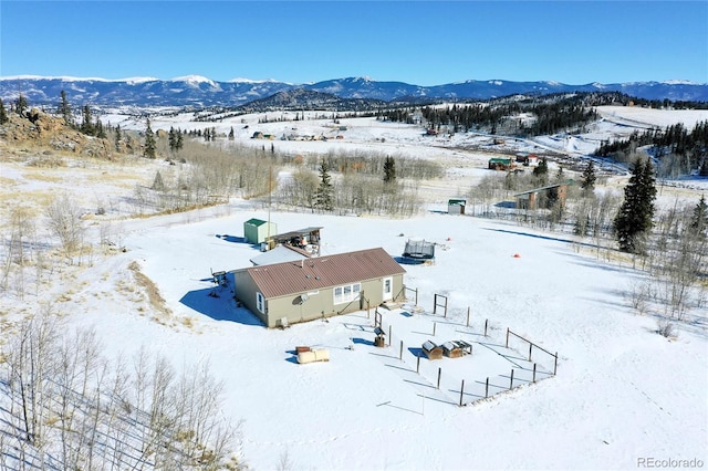 snowy aerial view with a mountain view