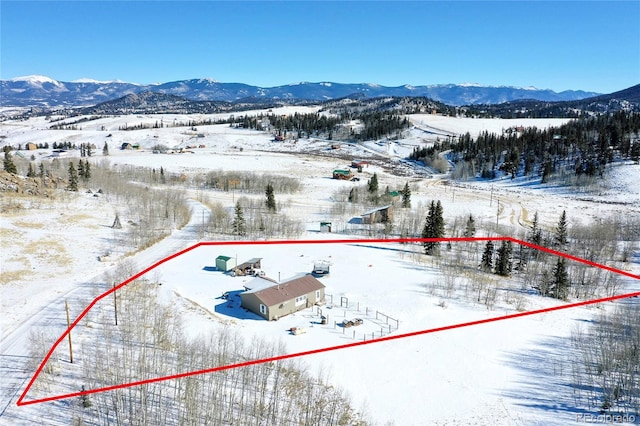 snowy aerial view featuring a mountain view