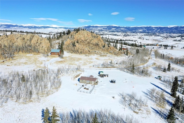 snowy aerial view with a mountain view