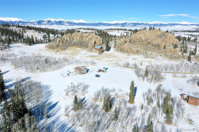 snowy aerial view with a mountain view