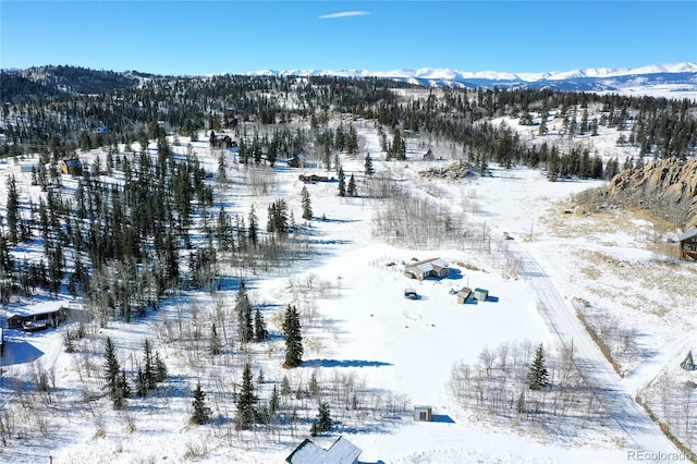 snowy aerial view with a mountain view