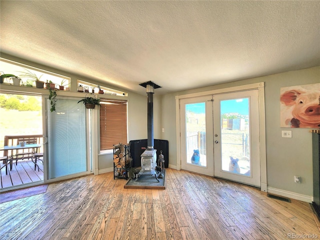 160 Shannon Ct, Rockvale, CO 81244 - sitting room with a textured ceiling, hardwood / wood-style flooring, french doors, and a wood stove
