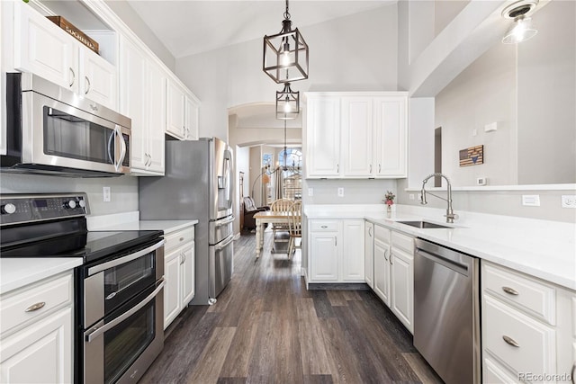 kitchen featuring hanging light fixtures, white cabinetry, appliances with stainless steel finishes, and sink