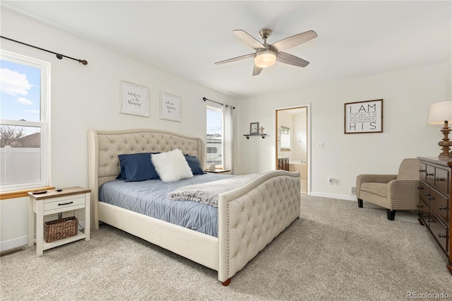 bedroom featuring connected bathroom, light colored carpet, and ceiling fan