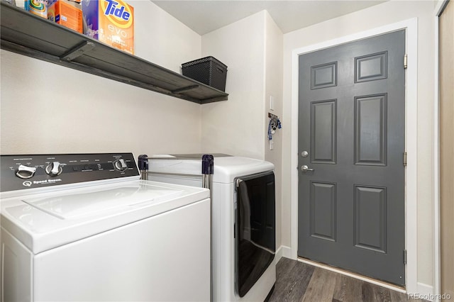 laundry area with washing machine and dryer and dark wood-type flooring