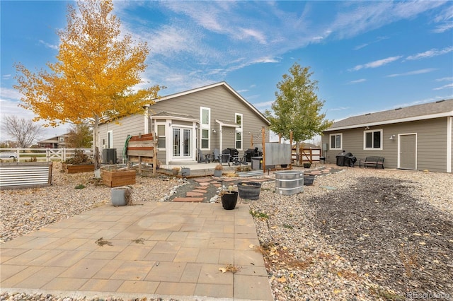 back of house with a patio area and central air condition unit