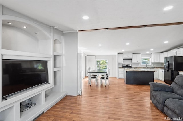 living room with sink and light wood-type flooring