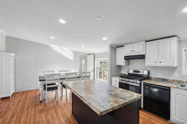 kitchen featuring black dishwasher, a center island, white cabinets, and light hardwood / wood-style floors