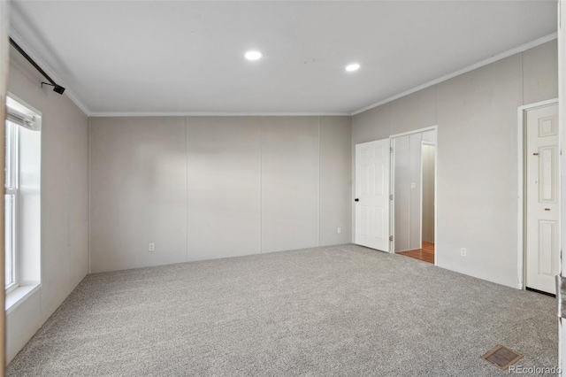 unfurnished bedroom featuring crown molding and light carpet