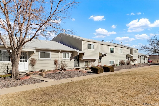 rear view of property with a yard