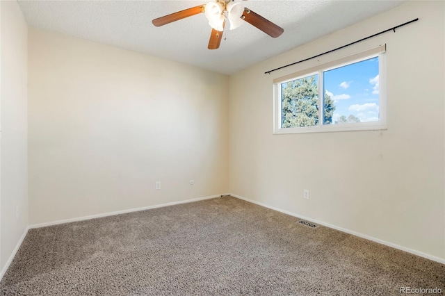 carpeted spare room featuring a textured ceiling, a ceiling fan, visible vents, and baseboards