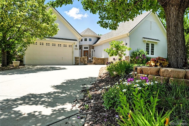 4944 W 107th Loop, Westminster, CO 80031 - view of front of home featuring stucco siding, concrete driveway, an attached garage, and roof with shingles