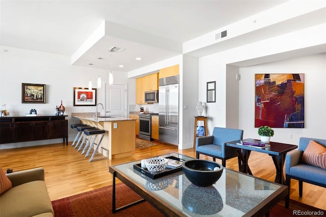 2001 Lincoln St Unit 1723, Denver, CO 80202 - living room with light wood-style floors and recessed lighting