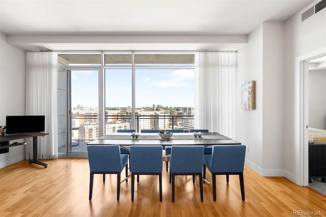 2001 Lincoln St Unit 1723, Denver, CO 80202 - dining area with light wood-style flooring and a view of city