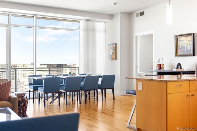 2001 Lincoln St Unit 1723, Denver, CO 80202 - dining space with light wood finished floors and baseboards