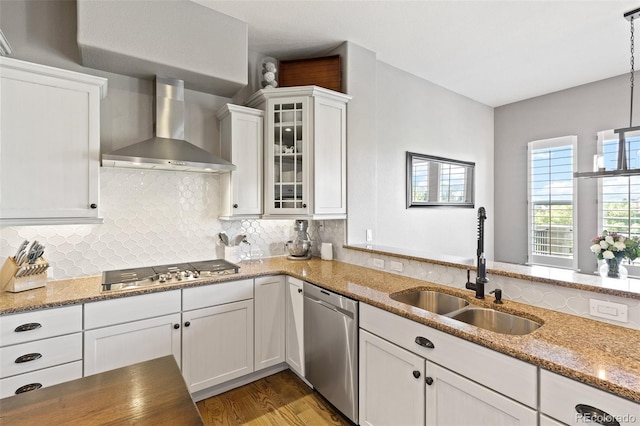 444 Pasada Way, Monument, CO 80132 - kitchen with stainless steel appliances, wall chimney exhaust hood, a sink, white cabinets, and light stone countertops