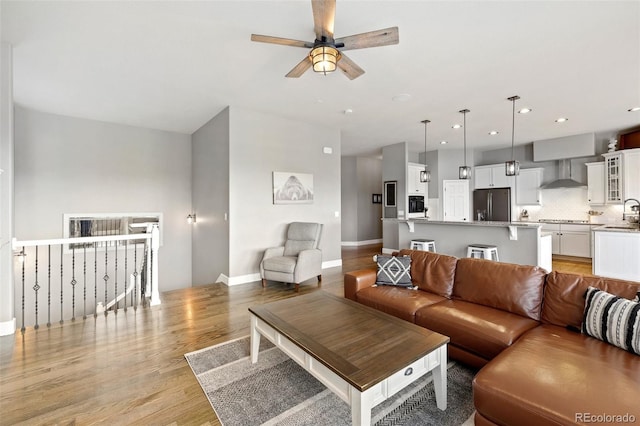 444 Pasada Way, Monument, CO 80132 - living area featuring a ceiling fan, light wood-style flooring, baseboards, and recessed lighting
