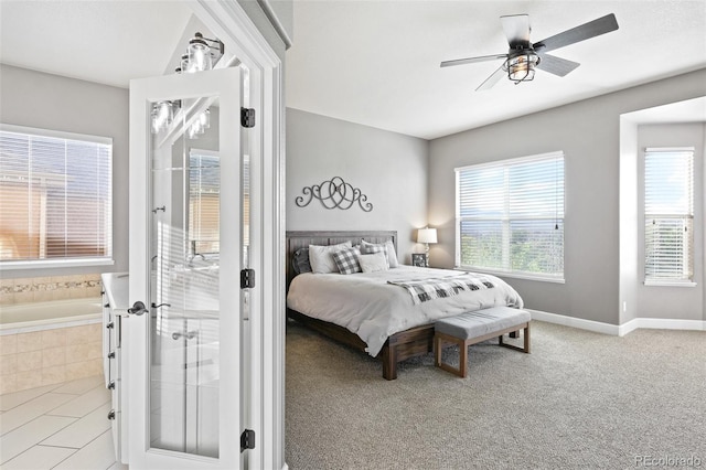 444 Pasada Way, Monument, CO 80132 - bedroom featuring multiple windows, a ceiling fan, and connected bathroom