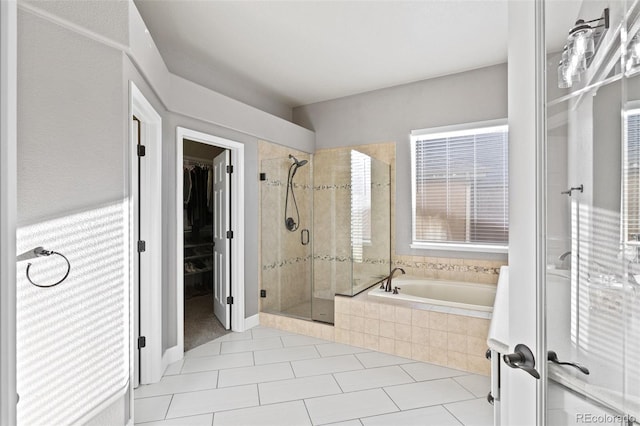 444 Pasada Way, Monument, CO 80132 - bathroom featuring a shower stall, a bath, a spacious closet, and tile patterned floors