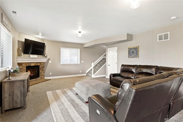 444 Pasada Way, Monument, CO 80132 - living area with stairway, carpet flooring, a fireplace, and baseboards