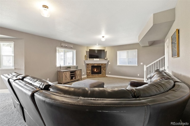 444 Pasada Way, Monument, CO 80132 - living room featuring carpet, healthy amount of natural light, a stone fireplace, and baseboards