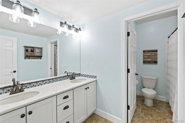 444 Pasada Way, Monument, CO 80132 - full bath with double vanity, toilet, and baseboards