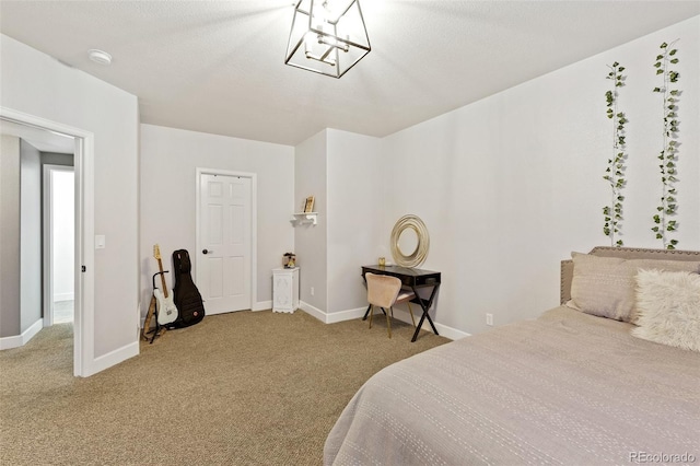 444 Pasada Way, Monument, CO 80132 - bedroom featuring carpet floors, baseboards, and a chandelier