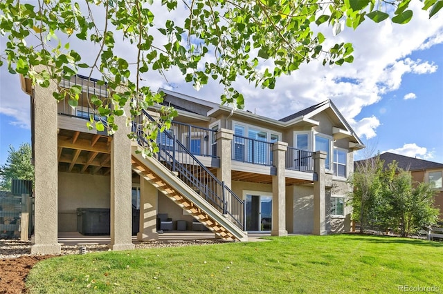 444 Pasada Way, Monument, CO 80132 - rear view of property featuring a lawn, stucco siding, a wooden deck, and stairs