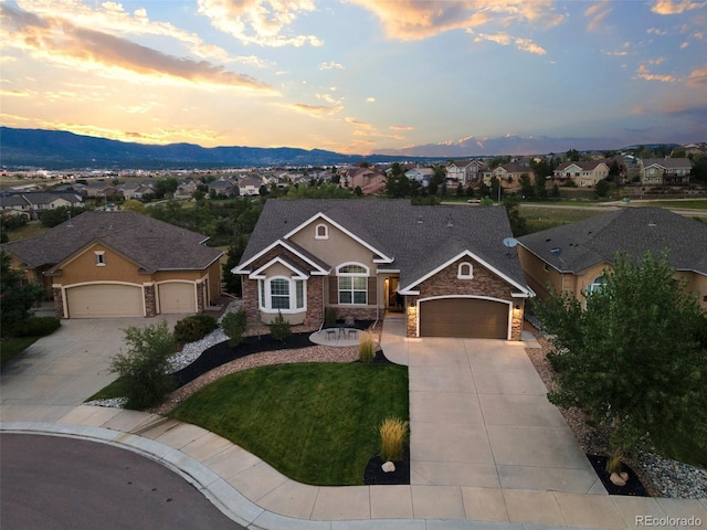 444 Pasada Way, Monument, CO 80132 - single story home featuring concrete driveway, an attached garage, stone siding, a residential view, and a mountain view