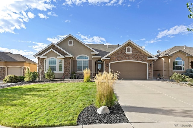 444 Pasada Way, Monument, CO 80132 - view of front of home with an attached garage, stucco siding, a front lawn, and driveway