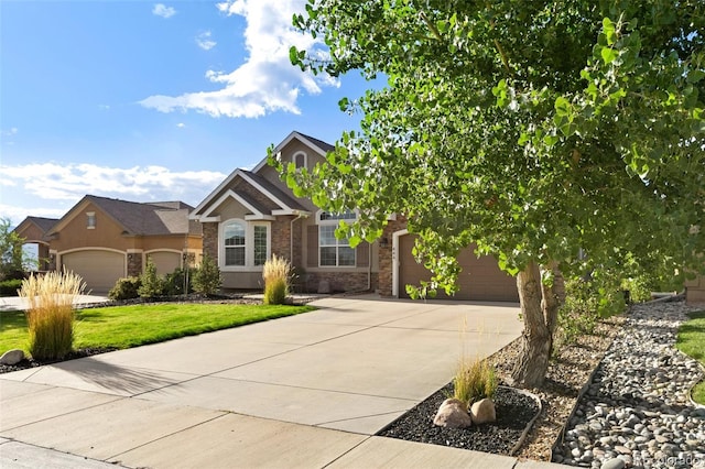 444 Pasada Way, Monument, CO 80132 - view of front of property with driveway, a garage, a front lawn, and stone siding