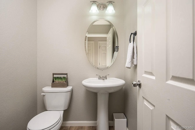 half bathroom with toilet and a sink
