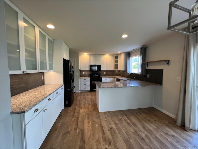 5414 Brookline Dr, Timnath, CO 80547 - kitchen featuring black appliances, a sink, a peninsula, tasteful backsplash, and recessed lighting