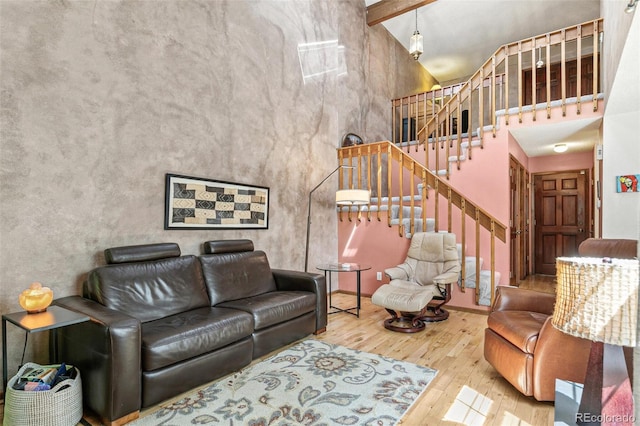 1950 S Helena St Unit D, Aurora, CO 80013 - living room featuring a towering ceiling, wood-type flooring, stairs, and beamed ceiling