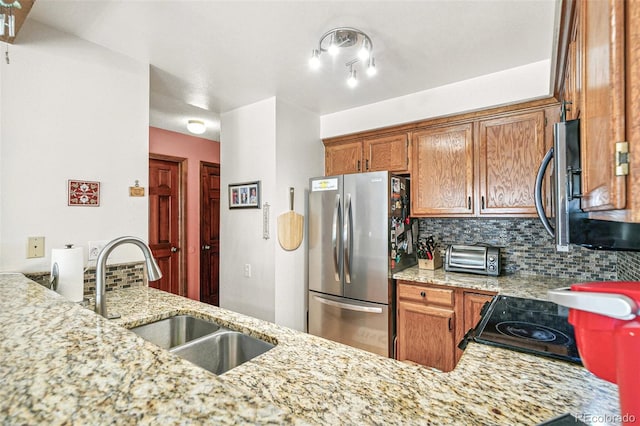 1950 S Helena St Unit D, Aurora, CO 80013 - kitchen with freestanding refrigerator, a sink, backsplash, and light stone countertops