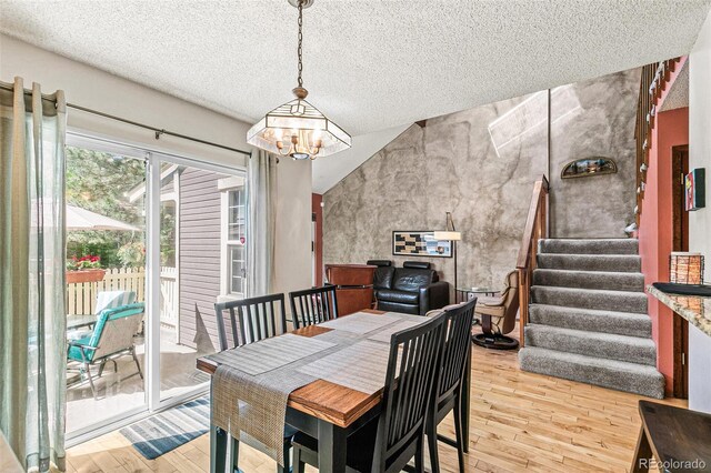 1950 S Helena St Unit D, Aurora, CO 80013 - dining room with stairs, light wood-type flooring, a textured ceiling, and a chandelier