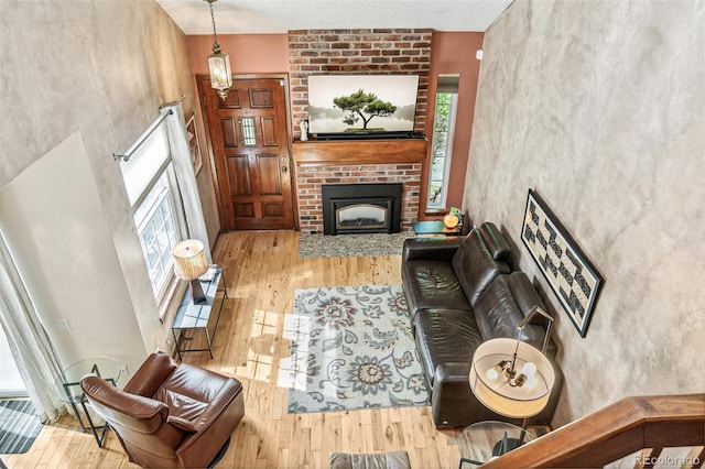 1950 S Helena St Unit D, Aurora, CO 80013 - living room featuring wood finished floors and a brick fireplace