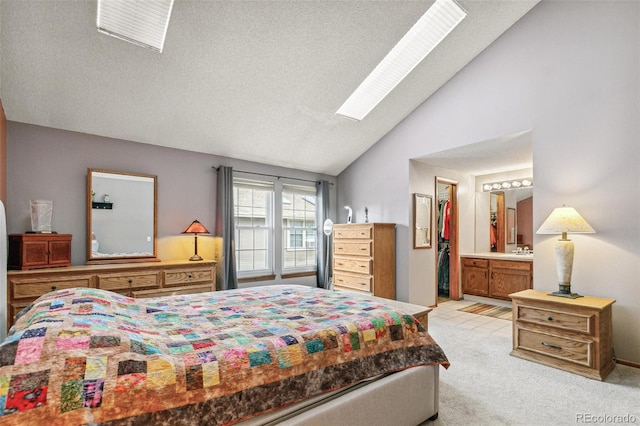 1950 S Helena St Unit D, Aurora, CO 80013 - bedroom with vaulted ceiling, light colored carpet, ensuite bath, a spacious closet, and a skylight